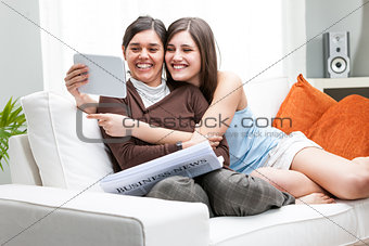 Mother and daughter using tablet to make a picture