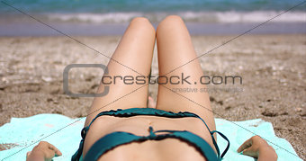 Body view of a young woman sunbathing