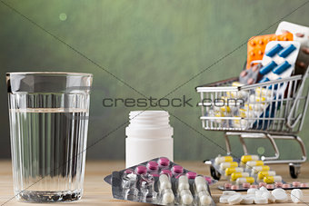 Set of glass water and pill blister packs