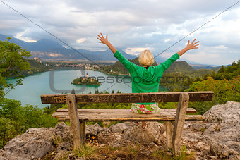 Woman enjoying panoramic view of Lake Bled, Slovenia.