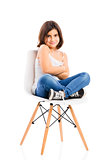 Beautiful young girl sitting on a chair