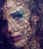 portrait of beauty young woman through lace close up mistery makeup
