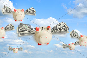 Piggy banks flying free in sky