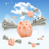 Pink piggy banks flying free in sky