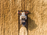air shot of harvester on the wheat field