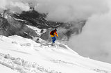 Snowboarder on off-piste slope an mountains in fog. 