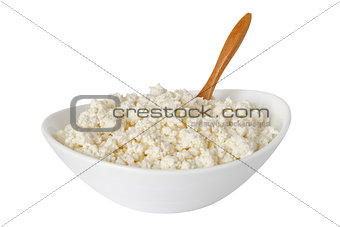 isolated cottage cheese with the wooden spoon in a bowl