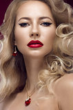 Beautiful blonde in a Hollywood manner with curls, red lips. Beauty face.