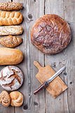 Delicious fresh bread on wooden background