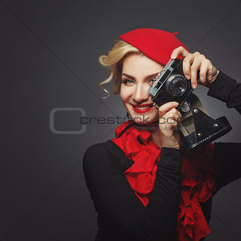 Beautiful lady with retro photo camera