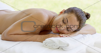 Woman relaxing on spa table  outdoor patio