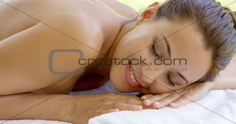 Woman relaxing on spa table  outdoor patio