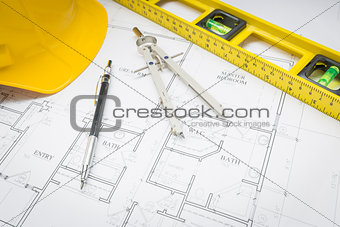 Hard Hat, Pencil, Level and Compass Resting on House Plans