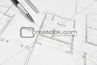 Engineer Pencil and Ruler Resting on House Plans