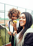 young pretty girlfriends hanging on tennis court, fashion stylish dressed swag, best friends happy smiling together