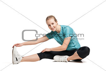 Beautiful sporty woman doing exercise on the floor