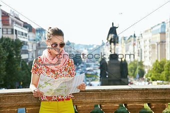 Smiling woman looking at map near National Museum in Prague