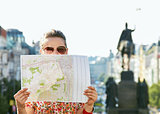 Woman hiding behind map while standing at Wenceslas Square