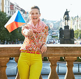 Smiling woman showing Czech flag at Wenceslas Square in Prague