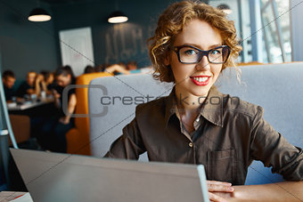 woman with laptop in cafe