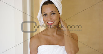 Woman wearing towel and with hair wrapped