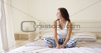 Young adult woman in plaid pants looking sideways
