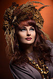 Beautiful young woman with dry flowers on head