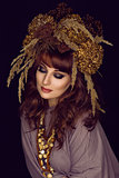 Beautiful young woman with dry flowers on head