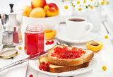 Fresh toasts with jelly, cup of coffee and fruits for breakfast