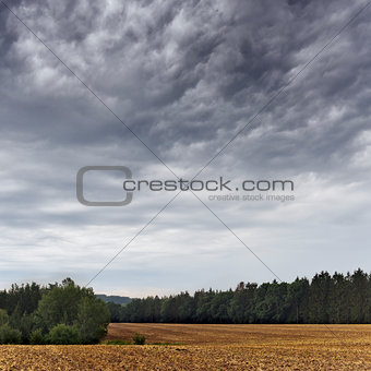 Summer landscape with dramatic cloudy sky