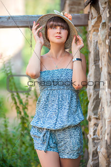 portrait of a girl in a hat on a summer day in nature