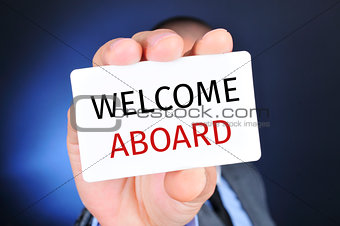 man with a signboard with the text welcome aboard