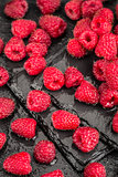 Fresh red raspberries on a slate background