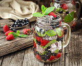 Detox drink with fresh berries in glass jars