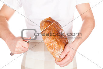 Baker cutting fresh made bread.