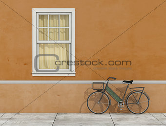 Old facade with window and bicycle