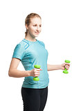 Athletic young woman works out with green dumbbells