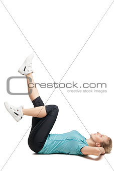 Beautiful sporty woman doing exercise on the floor