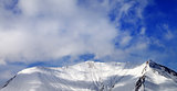 Panoramic view on off-piste snowy slope in wind day