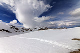 Snowy mountains and sky with clouds