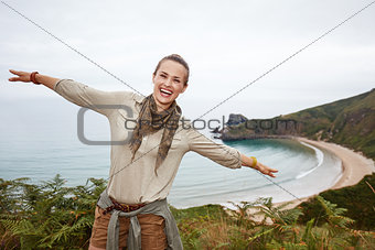 woman hiker having fun time in front of ocean view landscape