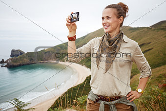 woman hiker taking photo with digital camera