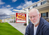 Senior Adult Man in Front of Real Estate Sign, House