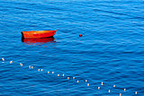 Red Row Boat Moored to Buoy