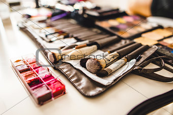 makeup cosmetics and brushes on the table