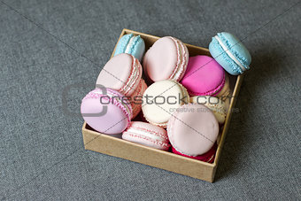 Colorful macaron in a box on the background of gray fabric