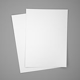 Two white paper sheets on gray