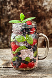 Detox drink with fresh berries in glass jars