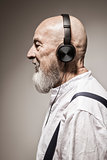 elderly bald head man with headphones