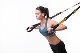 Woman training with suspension trainer sling